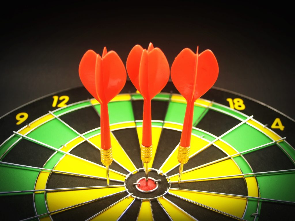 3 red darts close to target