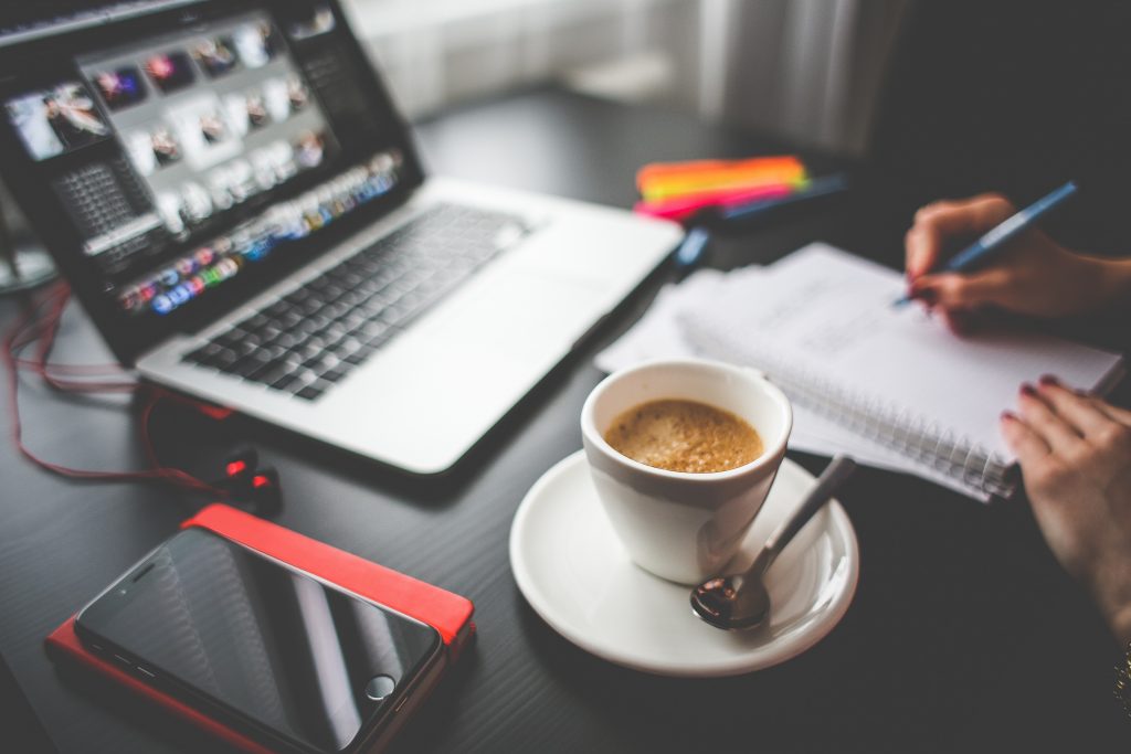 computer and coffee on the table while working in remote-first team